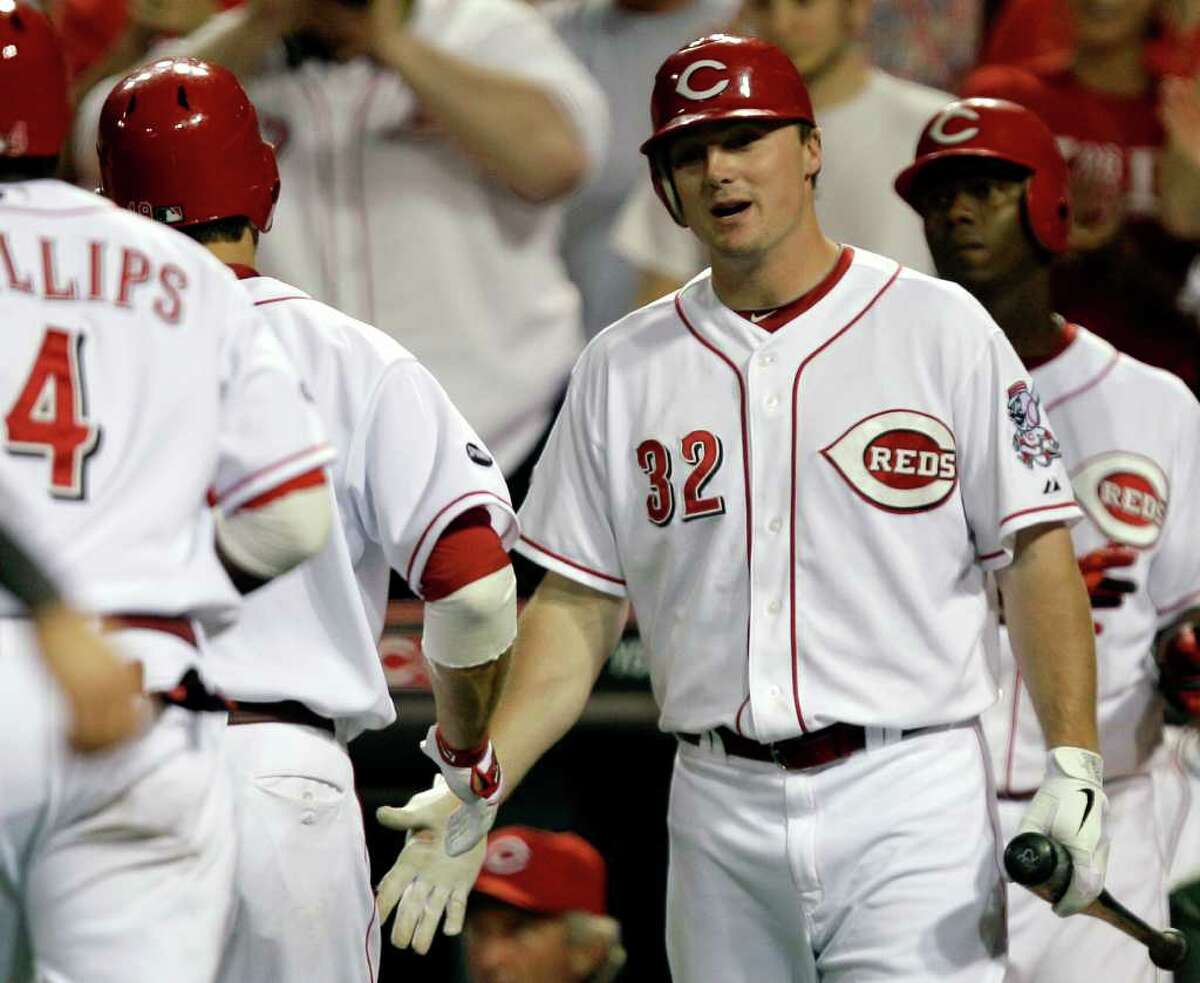 Cincinnati Reds' Jay Bruce (32) congratulates Joey Votto after Votto hit a two-run home run off Milwaukee Brewers relief pitcher Kameron Loe in the eighth inning of a baseball game, Wednesday, June 1, 2011, in Cincinnati. Bruce also had a two-run home run in the game won by Cincinnati 4-3. (AP Photo/Al Behrman)