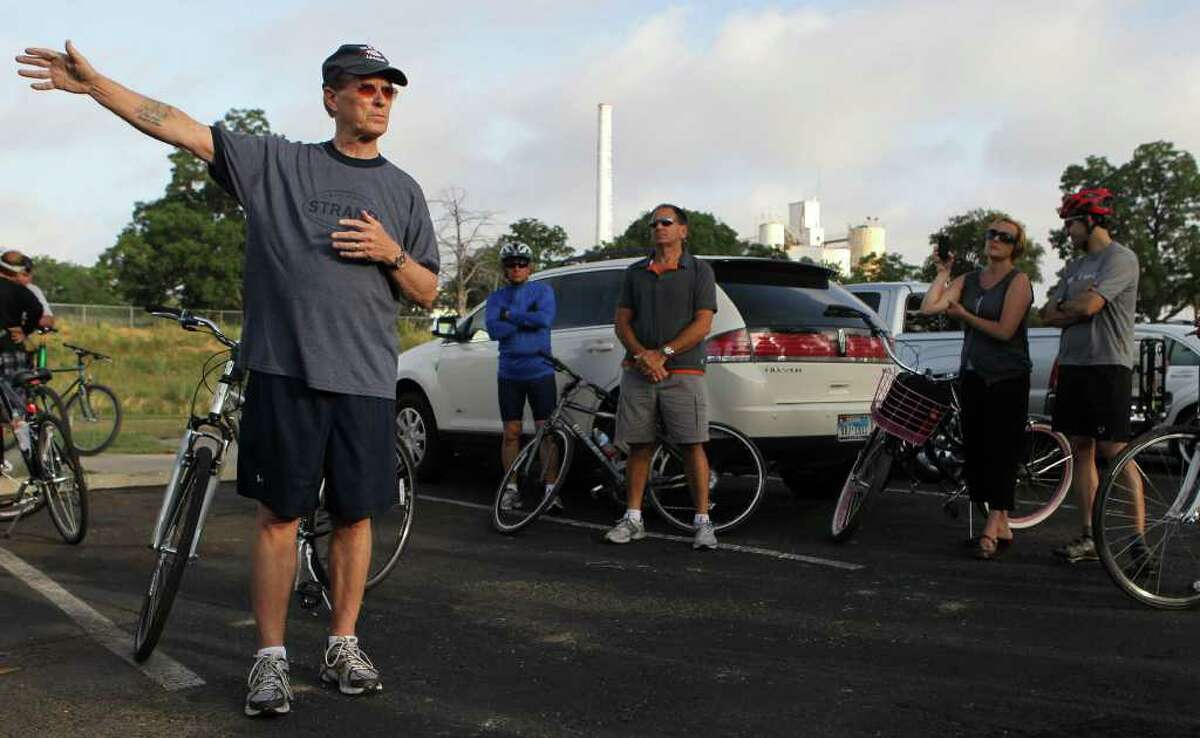 Bexar County Judge Nelson Wolff (left, gesturing) prepares to embark on a cycling tour of the Mission Reach portion of the San Antonio River on Thursday, June 2, 2011. Wolff led the tour to show what's been accomplished there and what developments are taking place.