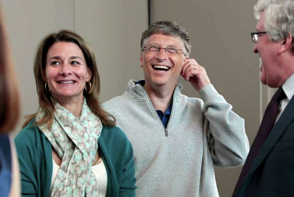 Melinda Gates, left, and husband Bill Gates laugh with Jeff Raikes following speaking at the opening reception of the Bill & Melinda Gates Foundation Thursday, June 2, 2011, in Seattle. The foundation formally opened the new headquarters Thursday evening, moving from scattered nondescript office buildings around Seattle to an architectural showcase in the center of its hometown.