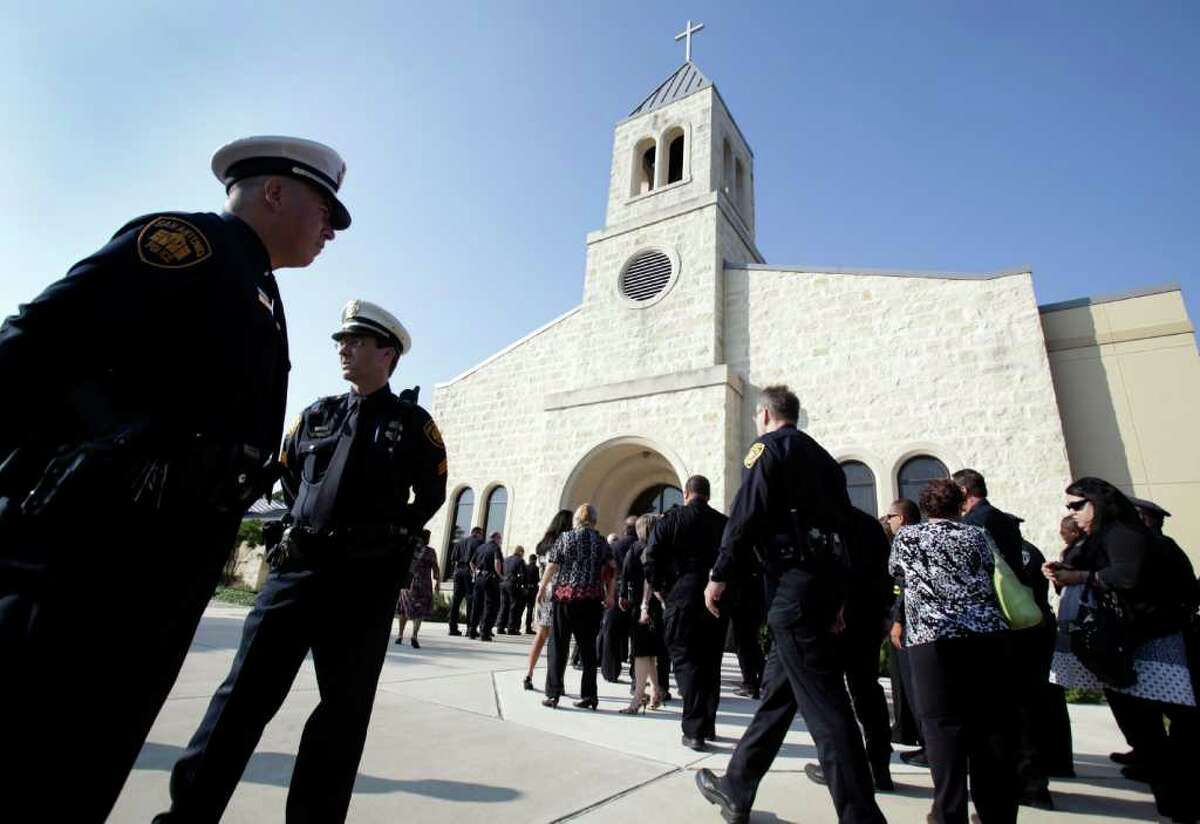 Law officers arrive for funeral services for Sgt. Kenneth Gary Vann of the Bexar County Sheriff Office, at St. Joseph of Honey Creek Catholic Church in Spring Branch, June 3, 2011.