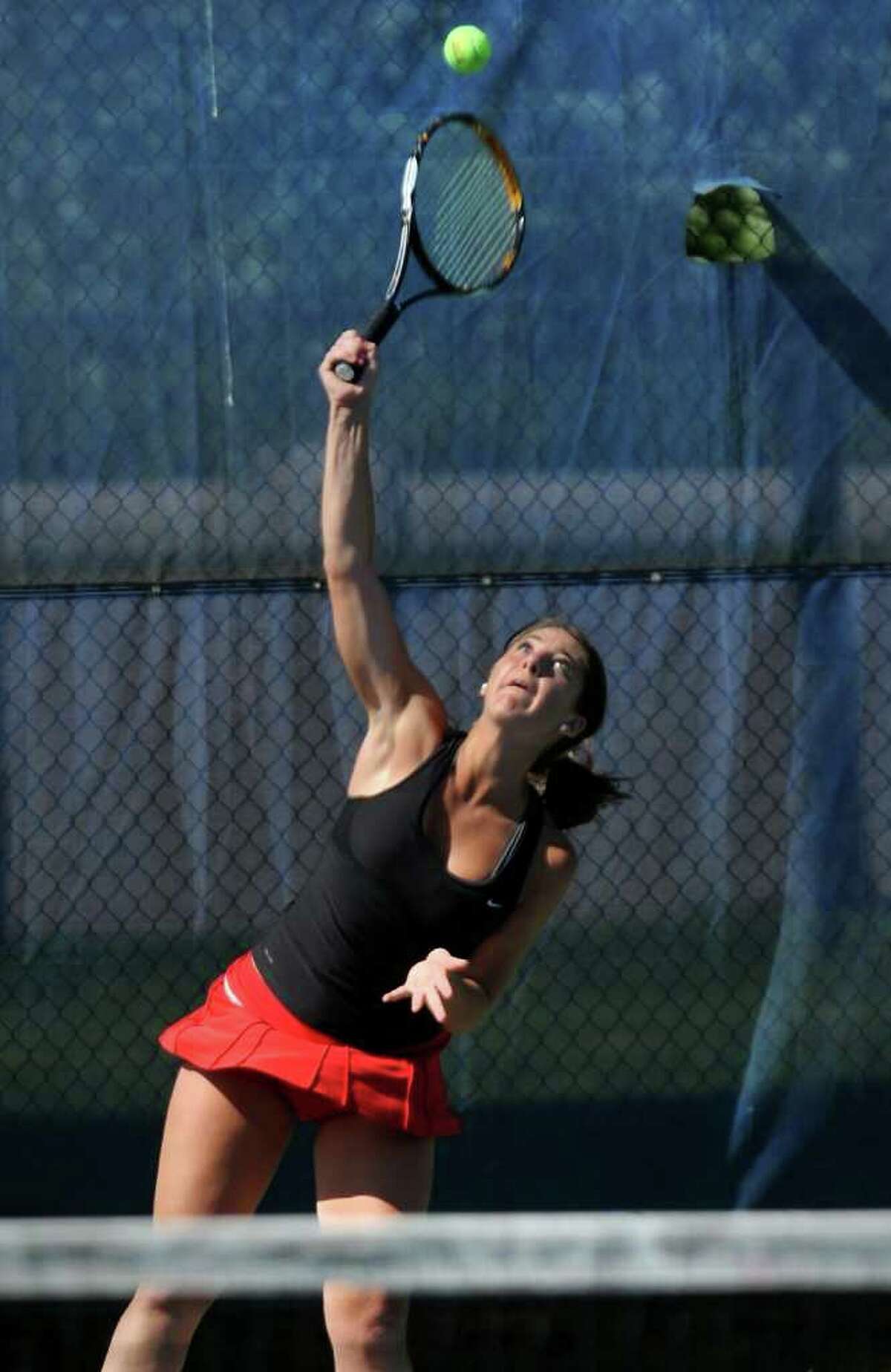 New Canaan's #2 singles Courtney Gallagher serves the ball, during state tournament girls tennis action against Glastonbury's Selina Nephuth at the Yale tennis complex in New Haven, Conn. on Friday June 3, 2011.