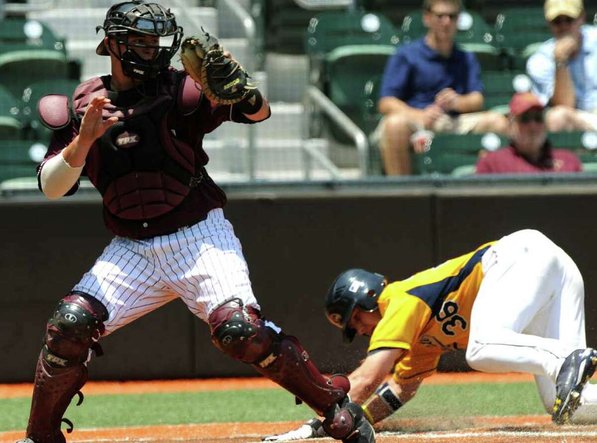 Kent State runner David Lyon slides safety into home as Texas State catcher Andrew Stumph receives the throw during the NCAA Baseball Austin Regional on Friday, June 3, 2011. BILLY CALZADA / gcalzada@express-news.net