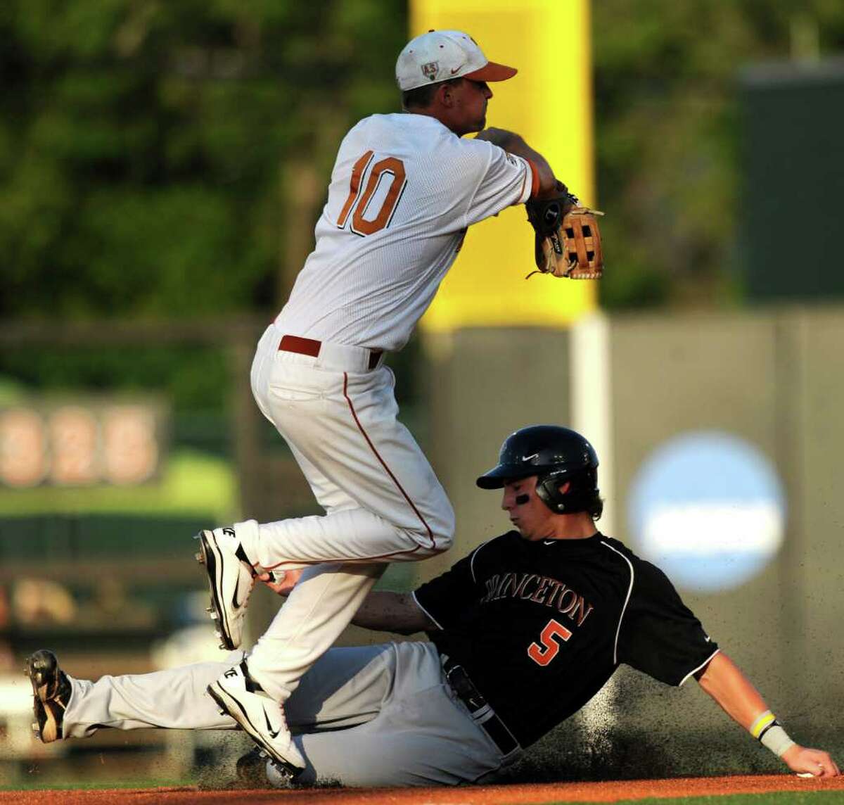 Princeton runner Alex Flink slides safely into second base as as Texas shortstop Brandon Loy throws to first during the NCAA Baseball Austin Regional on Friday, June 3, 2011. BILLY CALZADA / gcalzada@express-news.net