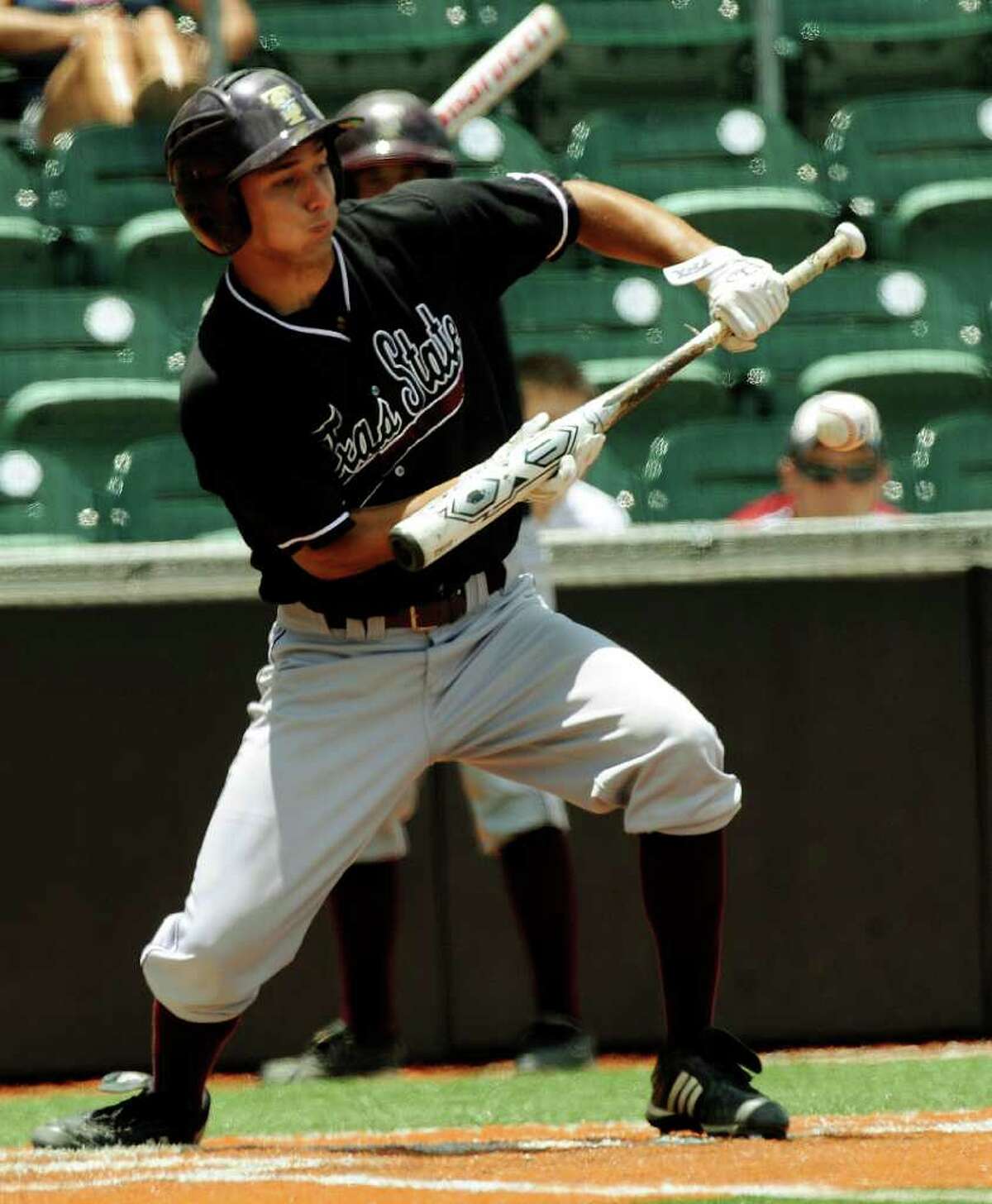 Christian Gallegos of Texas State bunts during NCAA Baseball Austin Regional action against Princeton on Saturday, June 4, 2011. Gallegos reached first on the play and was able to move a runner from second to third base. BILLY CALZADA / gcalzada@express-news.net