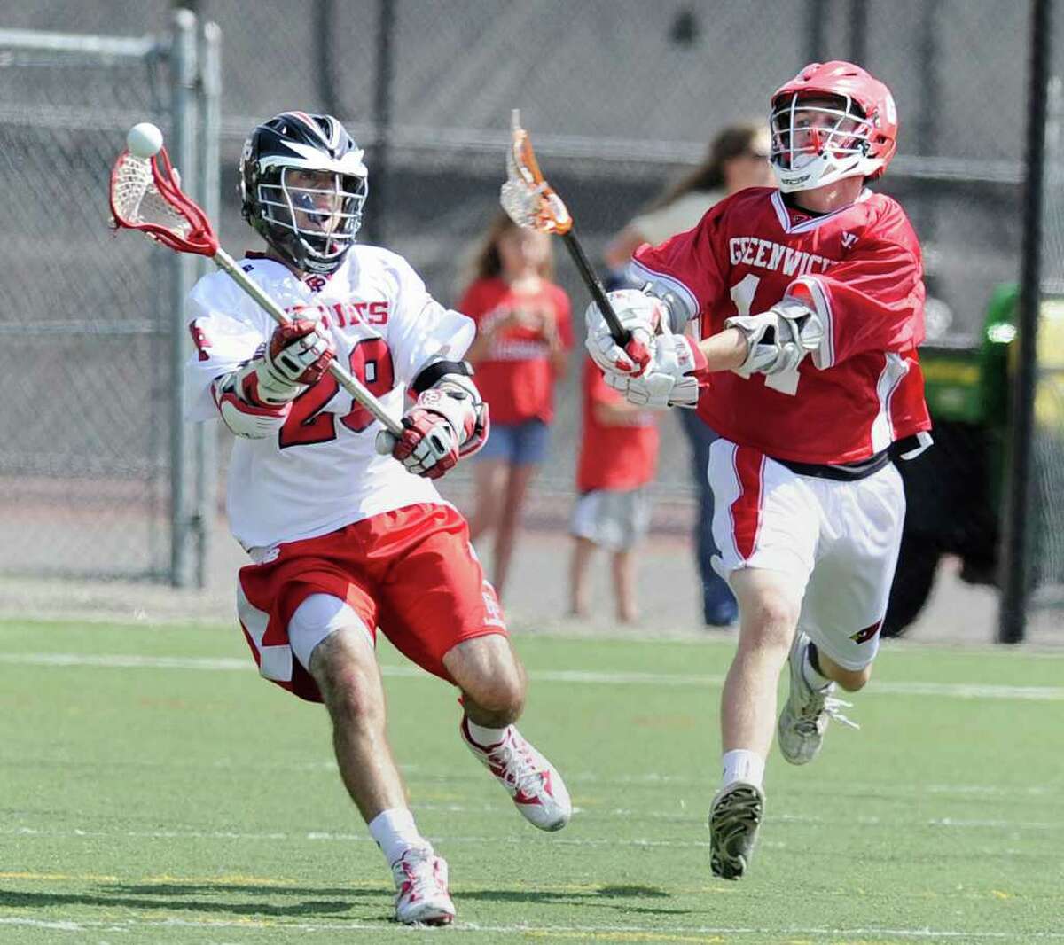 Joe McBride, left # 28 of Fairfield Prep, passes while being covered by Pete Cabrera, right # 11 of Greenwich High School, during the Class L boys lacrosse quarterfinal between Fairfield Prep and Greenwich High School at Fairfield University, Saturday afternoon, June 4, 2011.