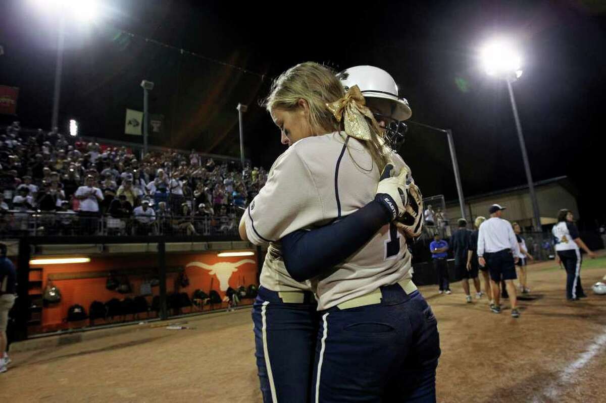 Maegan Ramirez (back) gets a long hug from Courtney Tietze after their season ends as O'Connor plays The Woodlands for the state 5A championship in softball at McCombs Field in Austin on June 4, 2011. Tom Reel/Staff