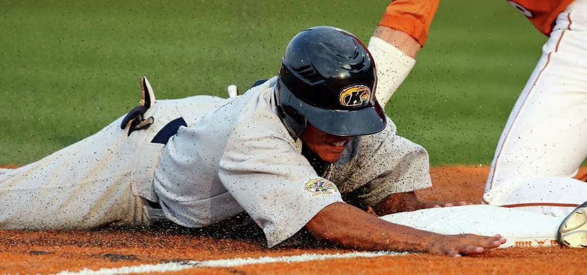 Kent State's Derek Toadvine slides safely into third base around the tag of Texas' Erich Weiss during the third inning.