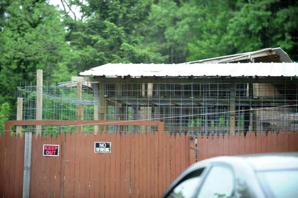 A caged area is seen beyond a fence where Steve Salton keeps his tigers and leopards on his property in Mayfield, N.Y. Thursday June 2, 2011. (Lori Van Buren / Times Union)