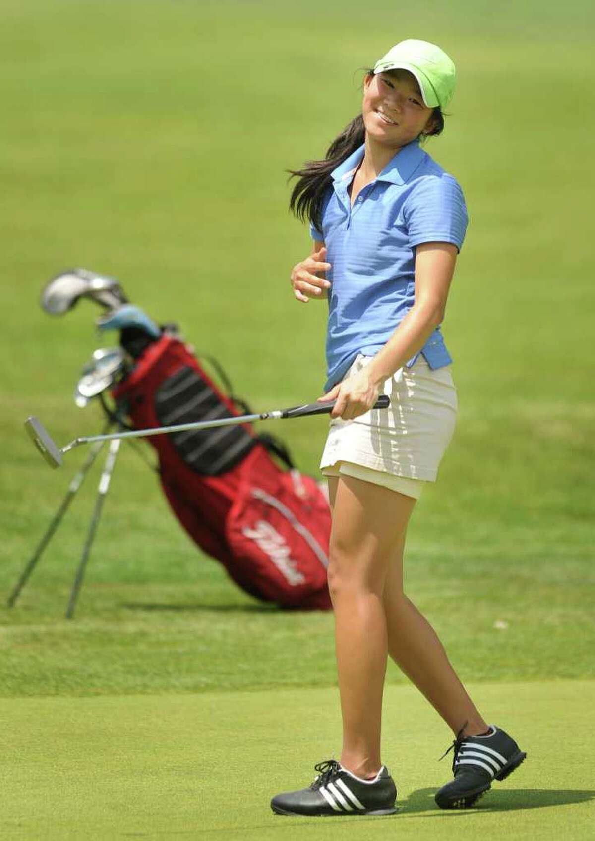 Darien's Izzy Lee reacts to nearly making a long putt on the 16th green at the 2011 Girls Golf State Tournament at Orange Hills Country Club in Orange on Tuesday, June 7, 2011.