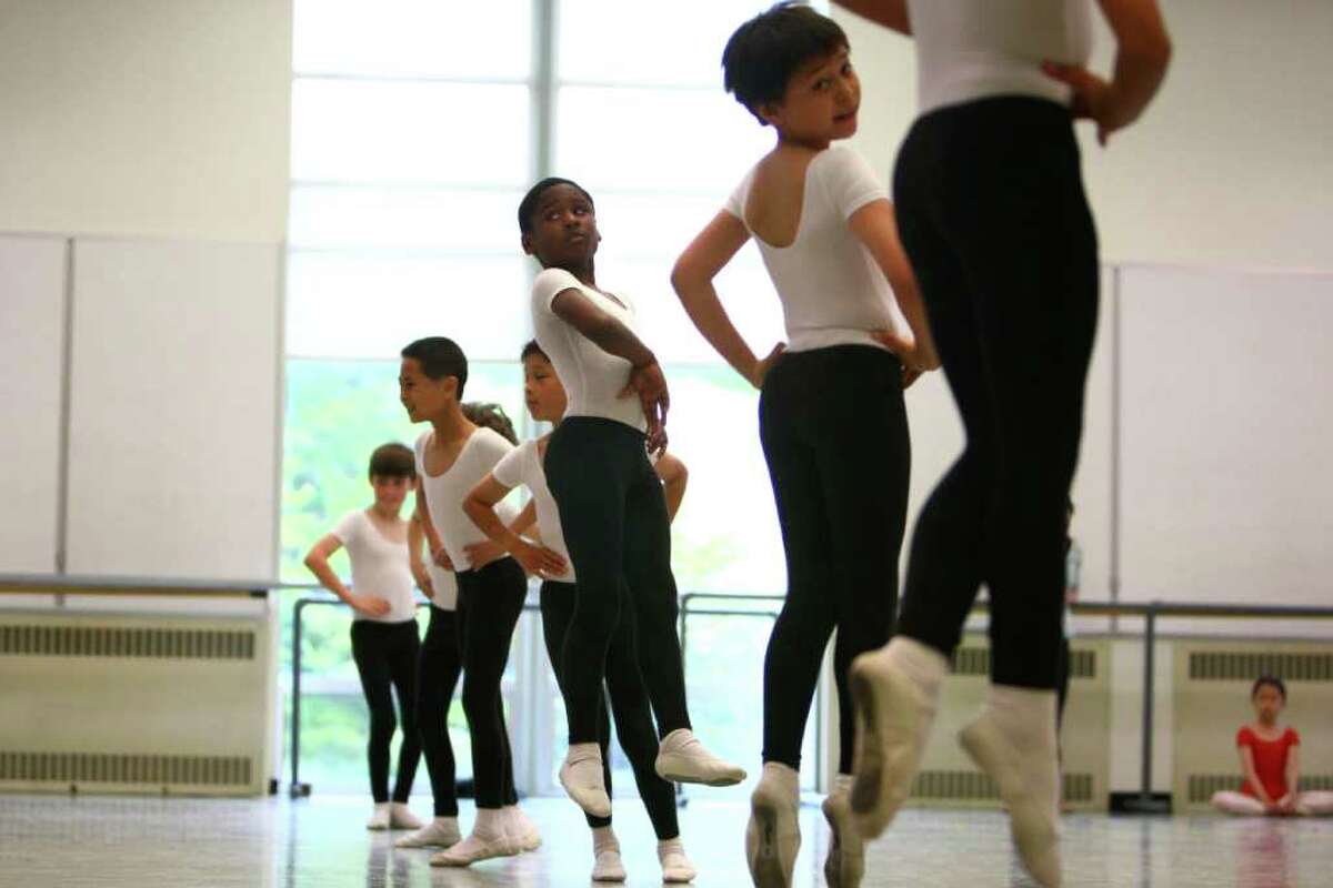 Students, including Kevonte Brown, center left, from Graham Hill Elementary, and Giovannie Dang, center right, from Arbor Heights, perform during Pacific Northwest Ballet's 17th annual DanceChance observation day.