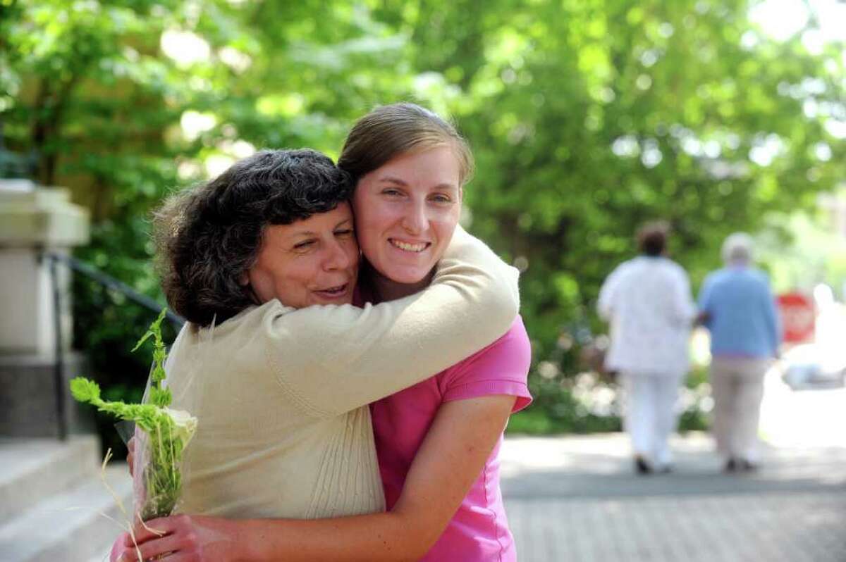 Christine Krieg, a daughter of Rose Marzullo, hugs her daughter Bridget during the Senior Center's dedication of the two benches in memory of Rose Marzullo and her sister Carmela Pecora, on Tuesday, June 7, 2011.