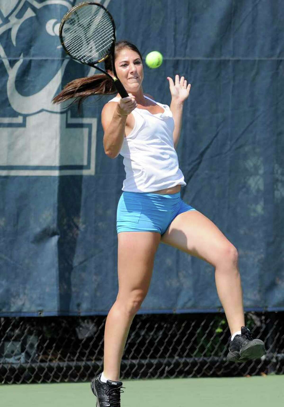 Courtney Gallagher of New Canaan High School in action against Kimmy Guerin of Weston High School during State Open Tennis Semifinals at Yale University, New Haven, Tuesday afternoon, June 7, 2011.