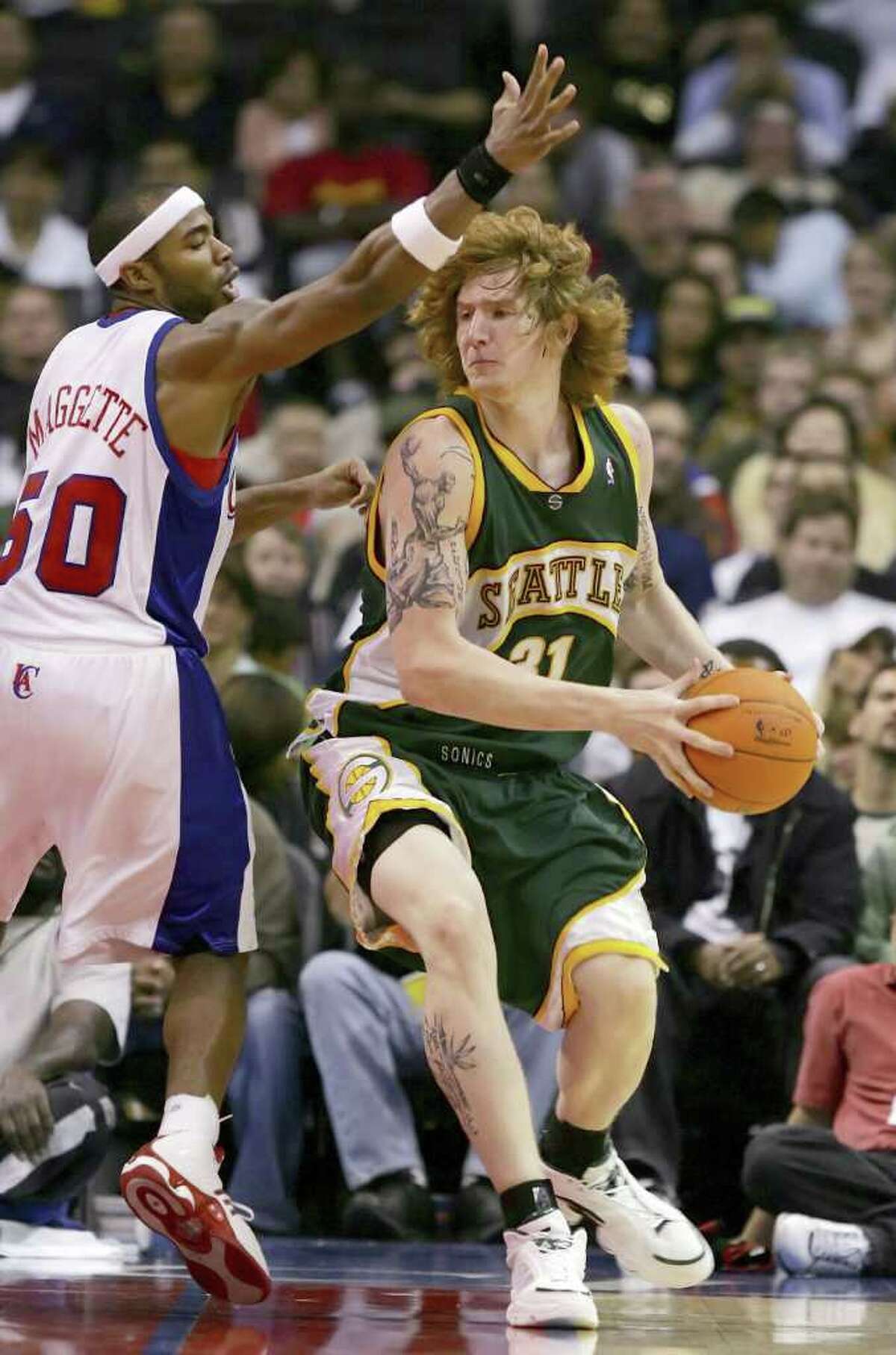 LOS ANGELES - OCTOBER 21: Robert Swift #31 of the Seattle SuperSonics looks to pass against Corey Maggette #50 of the Los Angeles Clippers on October 21, 2006 at Staples Center in Los Angeles, California. The Clippers won 86-82. NOTE TO USER: User expressly acknowledges and agrees that, by downloading and or using this photograph, User is consenting to the terms and conditions of the Getty Images License Agreement.