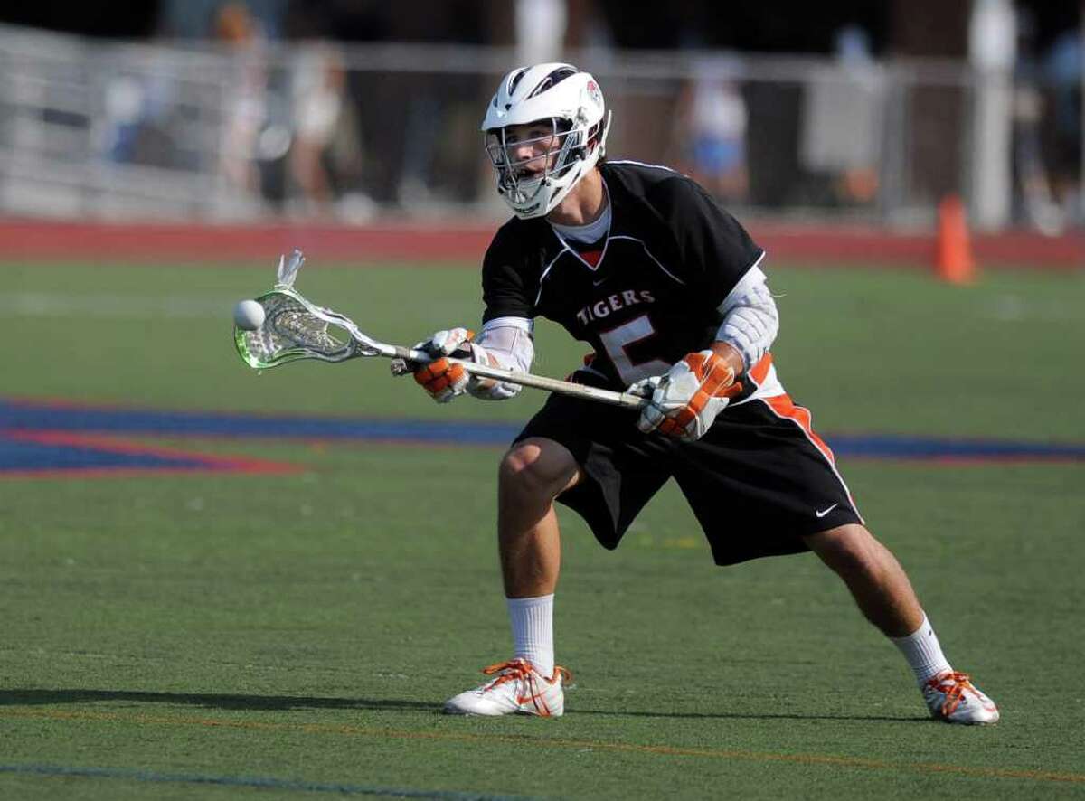 Ridgefield's Andrew Buckanavage passes the ball during Wednesday's game against Staples at Brien McMahon High School on June 8, 2011.