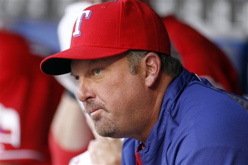 Texas Rangers hitting coach Rudy Jaramillo tips his hat to the