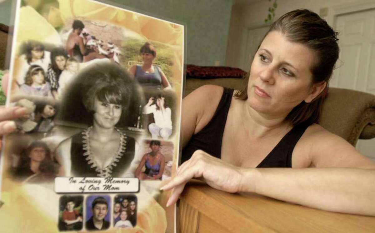 In this file photo Sherrie Passaro, of Danbury holds a poster of photographs in memory of her mother, Mary Badaracco, who disappeared from her home nearly 27 years ago.