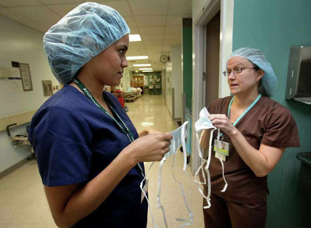 Dr. Kristin Brozena (right) gives hands-on instruction on how to prepare for surgery to Lauren Armendariz, a UT-Austin nutrition student. The instruction on Thursday, June 9, 2011, took place at University Hospital.