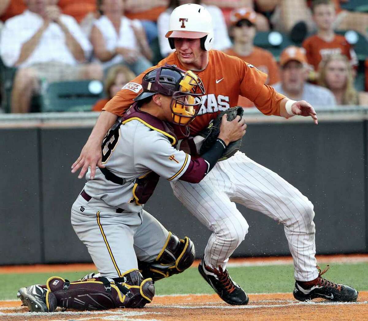 SPORTS Longhorn runner Jacob Felts is blocked from the plate by catcher Austin Barnes after being forced to try to take home in the seventh as The University of Texas Longhorns play Arizona State at Disch-Falk Field in Austin on June 10, 2011. Tom Reel/Staff