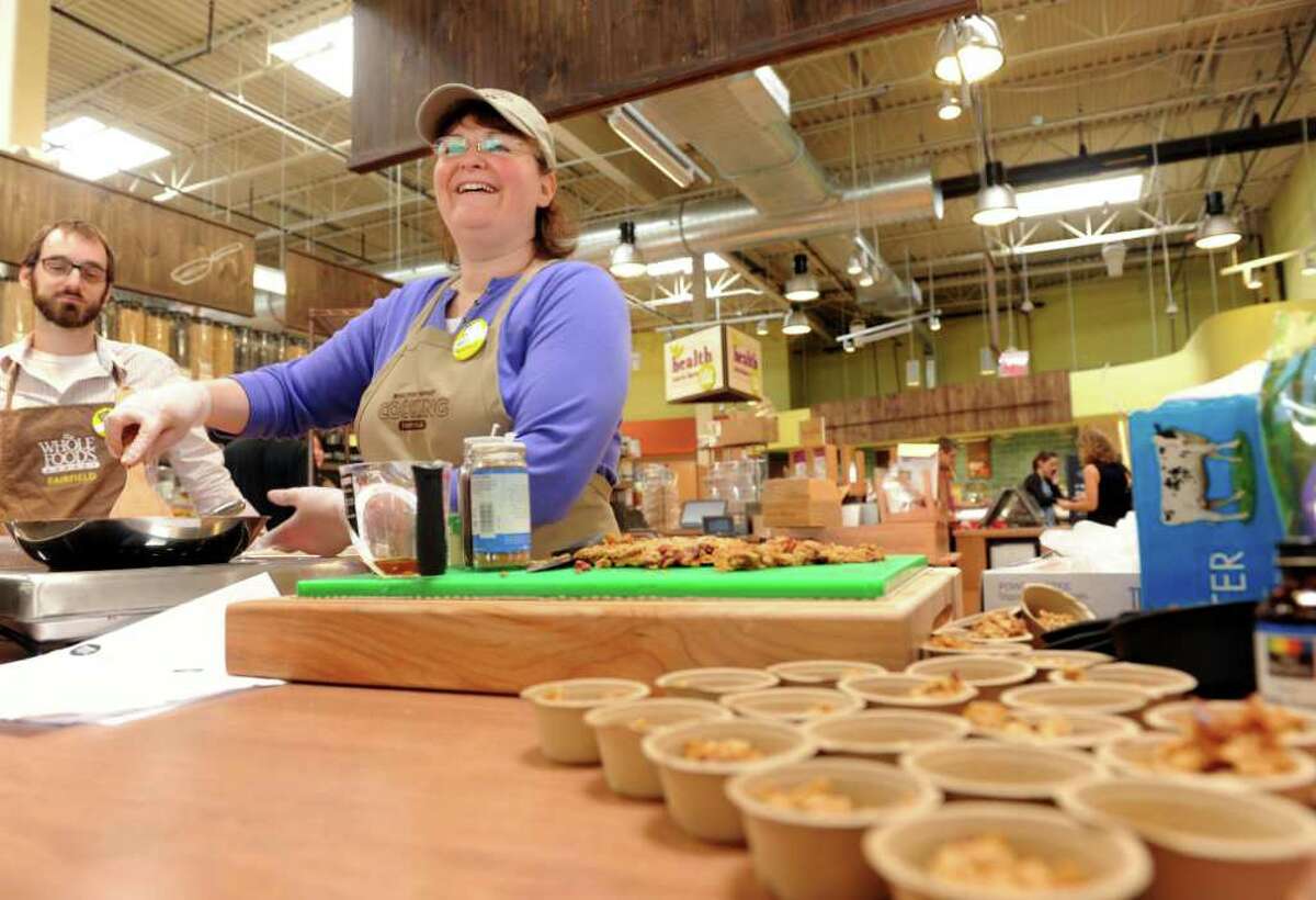 Cooking coach Michelle Ryan, of Milford, whips up homemade granola in the bulk foods section at the new Whole Foods market in Fairfield, Conn. Wednesday, June 1, 2011. The new store opens Friday, June 3, 2011.