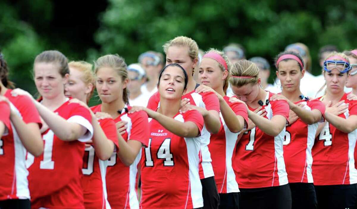 Brooke Swift, # 14 of Greenwich High School, and her teammates during the National Anthem at the start of the Class L girls lacrosse championship between Greenwich High School and Glastonbury High School at Bunnell High School, Stratford, Saturday, June 11, 2011. Greenwich won the state title, 12-10.