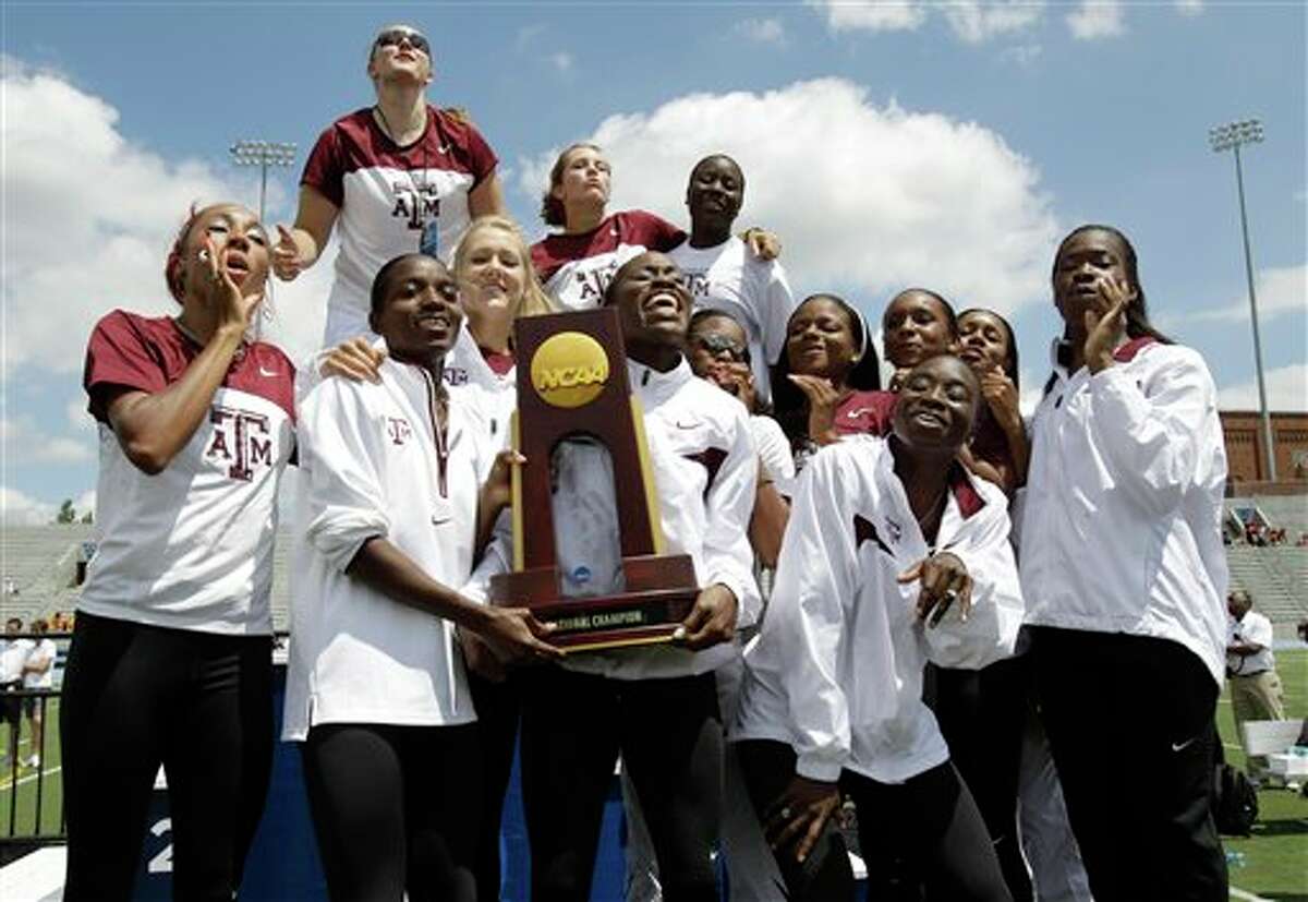 The Texas A&M women's team celebrates with the trophy after winning the team title at the NCAA college outdoor track and field championships, Saturday, June 11, 2011, at Drake Stadium in Des Moines, Iowa. (AP Photo/Charlie Neibergall)