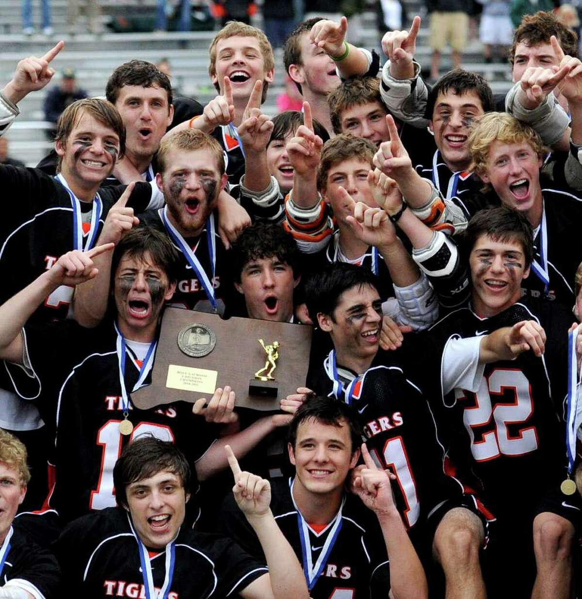 Ridgefield lacrosse players celebrate their win after Saturday's Division L final at Brien McMahon High School on June 11, 2011.