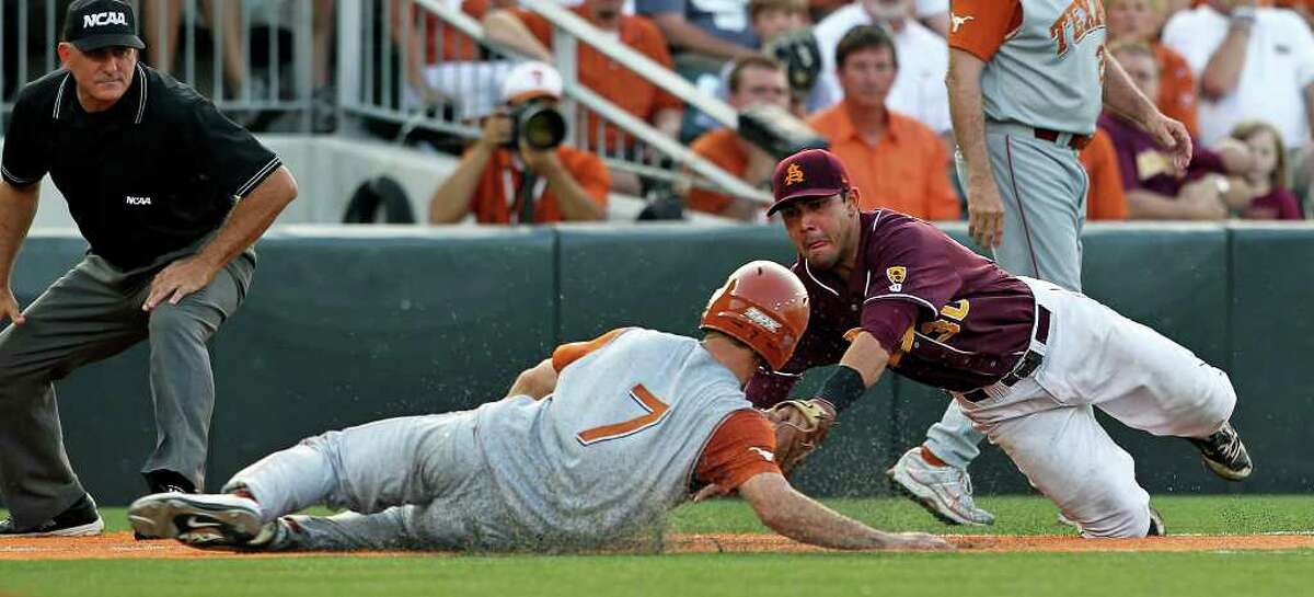 SPORTS Jordan Etier is out at third under the tag of Riccio Torrez in the seventh inning after trying to gain the base on a sacrifice fly as The University of Texas Longhorns play Arizona State in game 2 of their super regional playoff series at Disch-Falk Field in Austin on June 11, 2011. Tom Reel/Staff