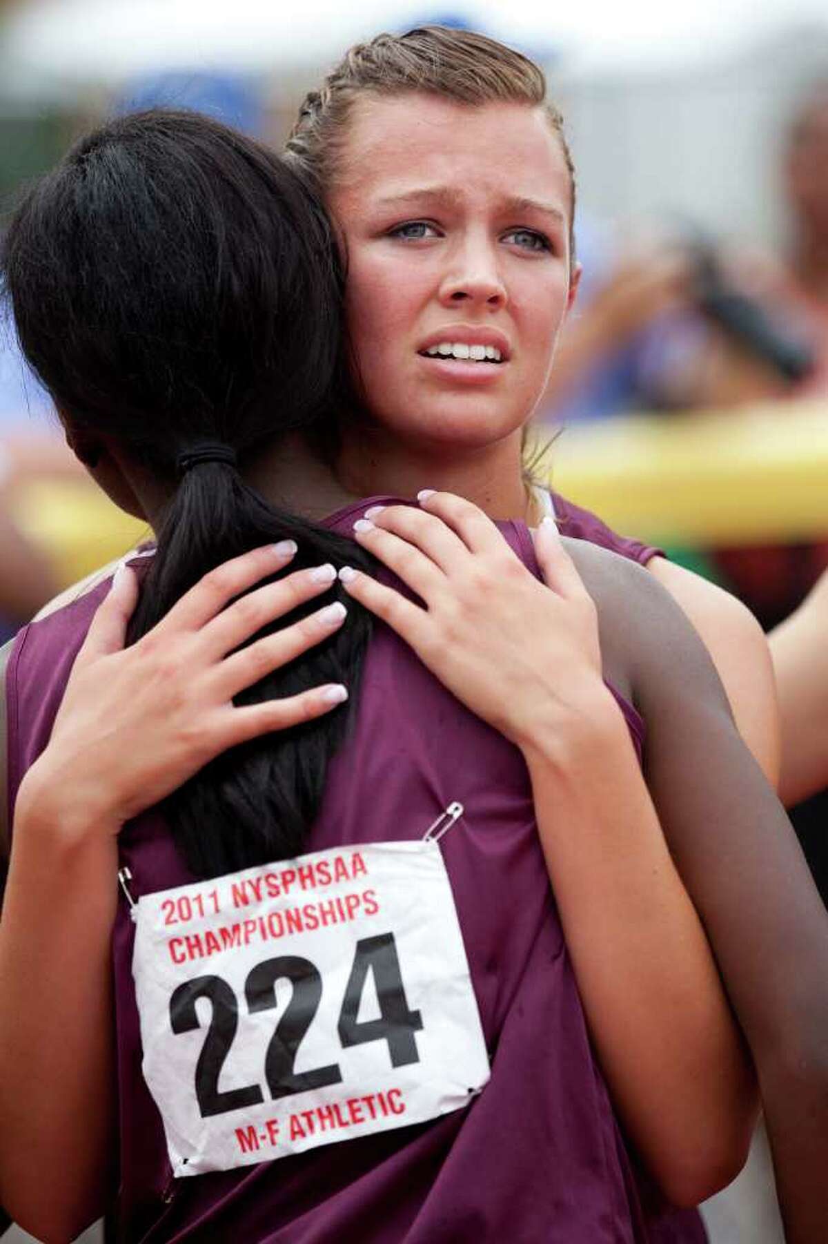 Kristina Lenge and Uwa Omorogbe embrace after their loss in the 4x400 at the New York State Track and Field Championships. (Brett Carlsen/Special to the Times Union)