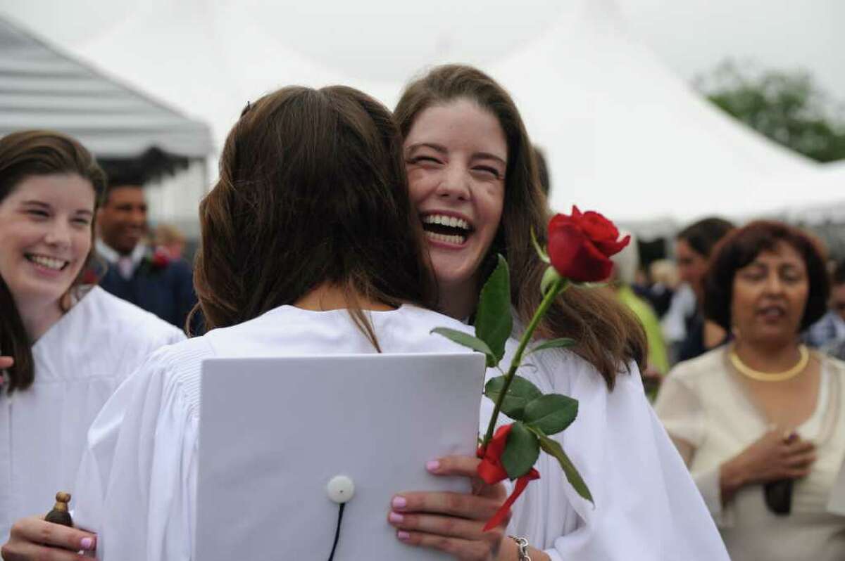 Emily Wilson, facing, hugs fellow graduate Katherine Gimpel after the King Low Heywood Thomas Class of 2011 graduation ceremony in Stamford, Conn., June 12, 2011. Retired New York Life Insurance Company President Fred Sievert gave the commencement address.