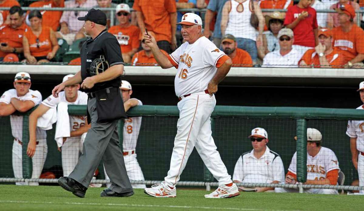 Longhorns coach Augie Garrido gets the umpires to talk about the controversial play which would have advanced an Arizona State runner to third in the early innings as the Texas Longhorns play Arizona State in game 3 of their super regional playoff series at Disch-Falk Field in Austin on June 12, 2011. Tom Reel/Staff