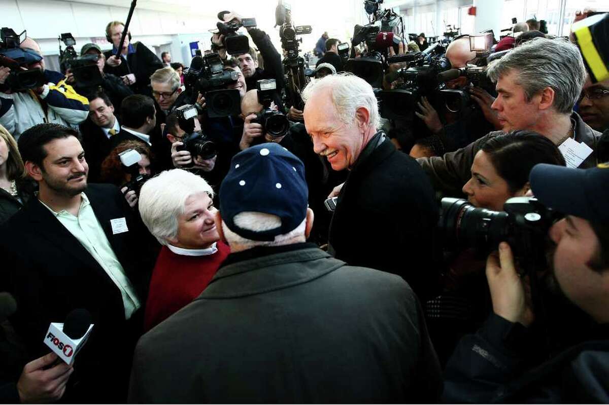 Captain Chesley Sullenberger is mobbed by media as he meets passengers from the US Airways flight 1549 during a reunion to mark the one year anniversary on January 15, 2010 in New York.