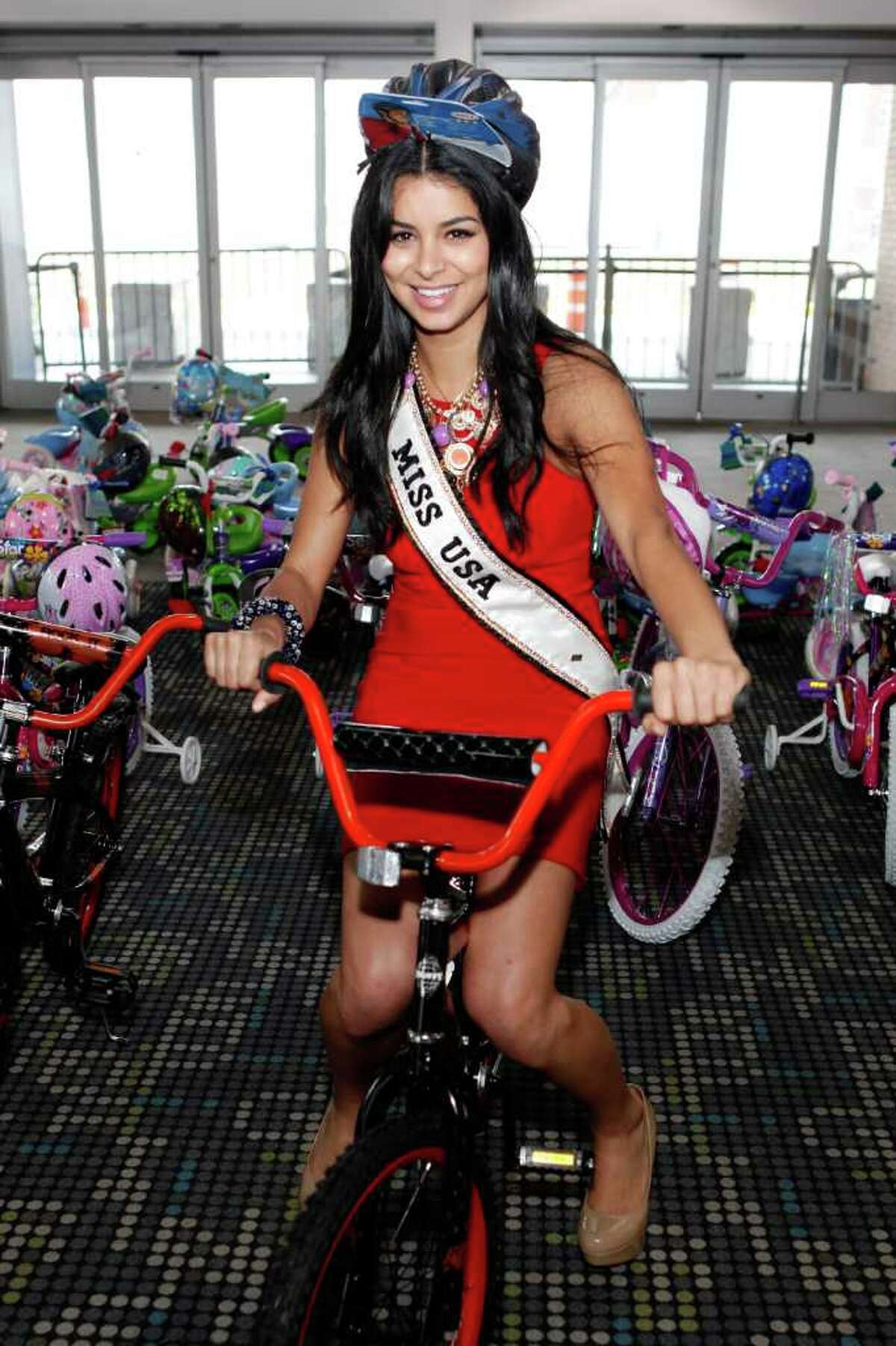 Miss USA Rima Fakih builds bikes for children at Pier 88 on May 26, 2011 in New York City.
