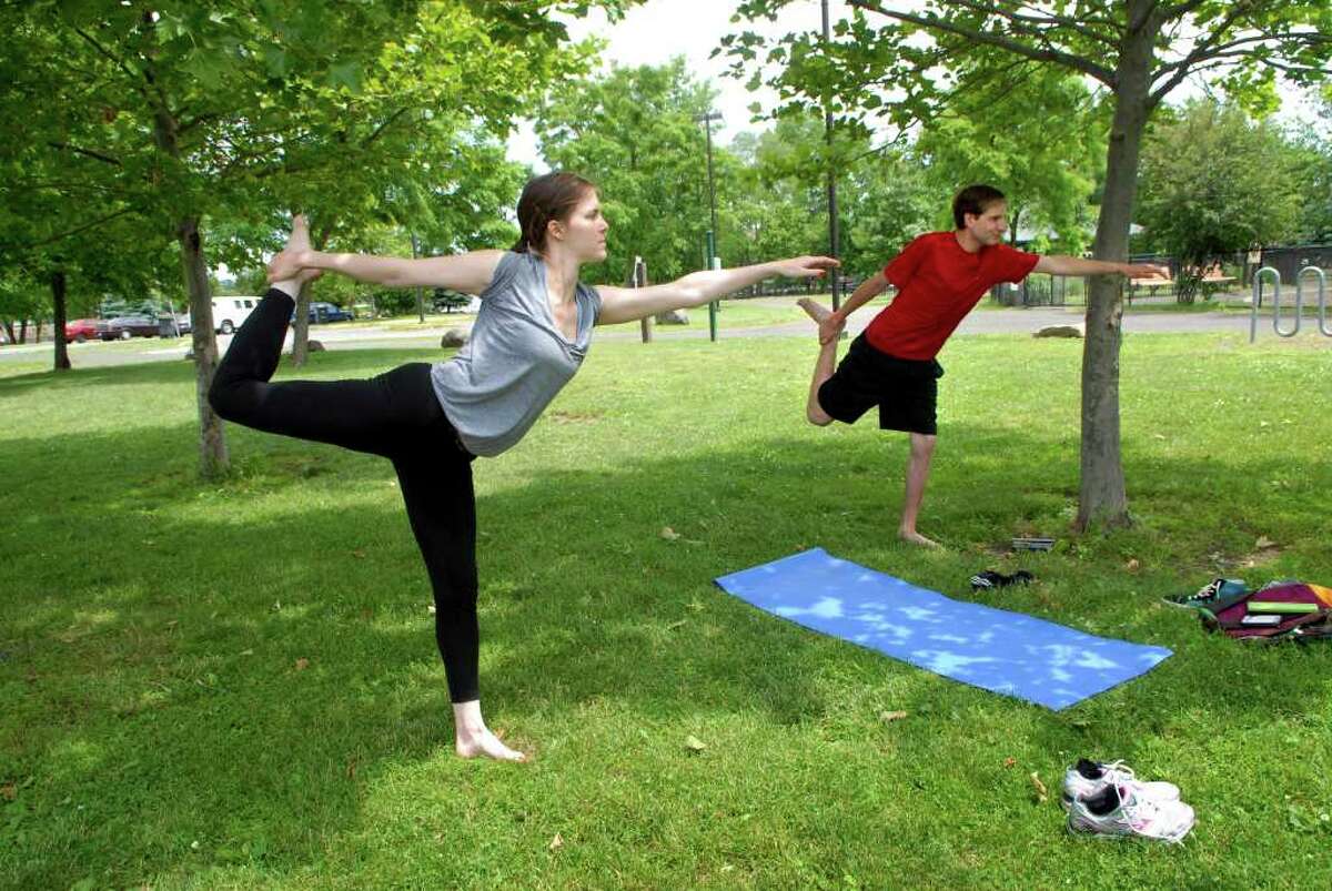 Julie Michael and D. J. Weiss do yoga in Kosciuszko Park in Stamford, Conn. on Monday June 13, 2011, their day off from their jobs at the Big Apple Circus. Michael is a wardrobe supervisor and Weiss works on the ring crew and is also a clown but isn't performing in this show.