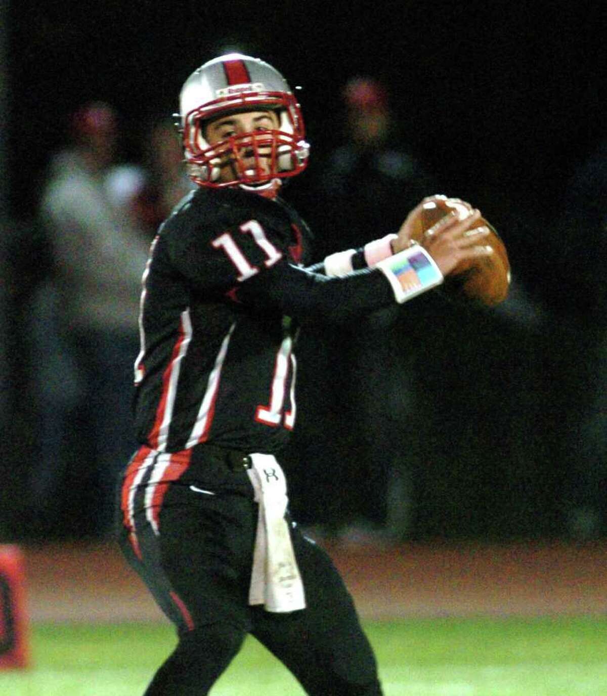Pomperaug's 11, Kellen Croce sets up for a pass during the football game against Brookfield at Southbury High School Nov. 5, 2010.