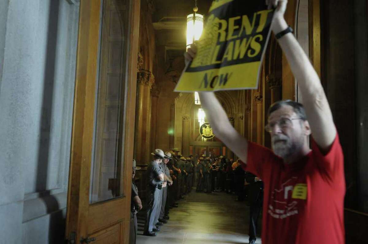 New York State Troopers stand in a line outside of Governor Andrew Cuomo's capitol offices as New York City tenants and tenant advocates hold a rally inside the capitol on Monday afternoon, June 13, 2011 in Albany. The group was calling on lawmakers to pass a bill with stronger rent laws and not just extend the existing rent control law. (Paul Buckowski / Times Union)