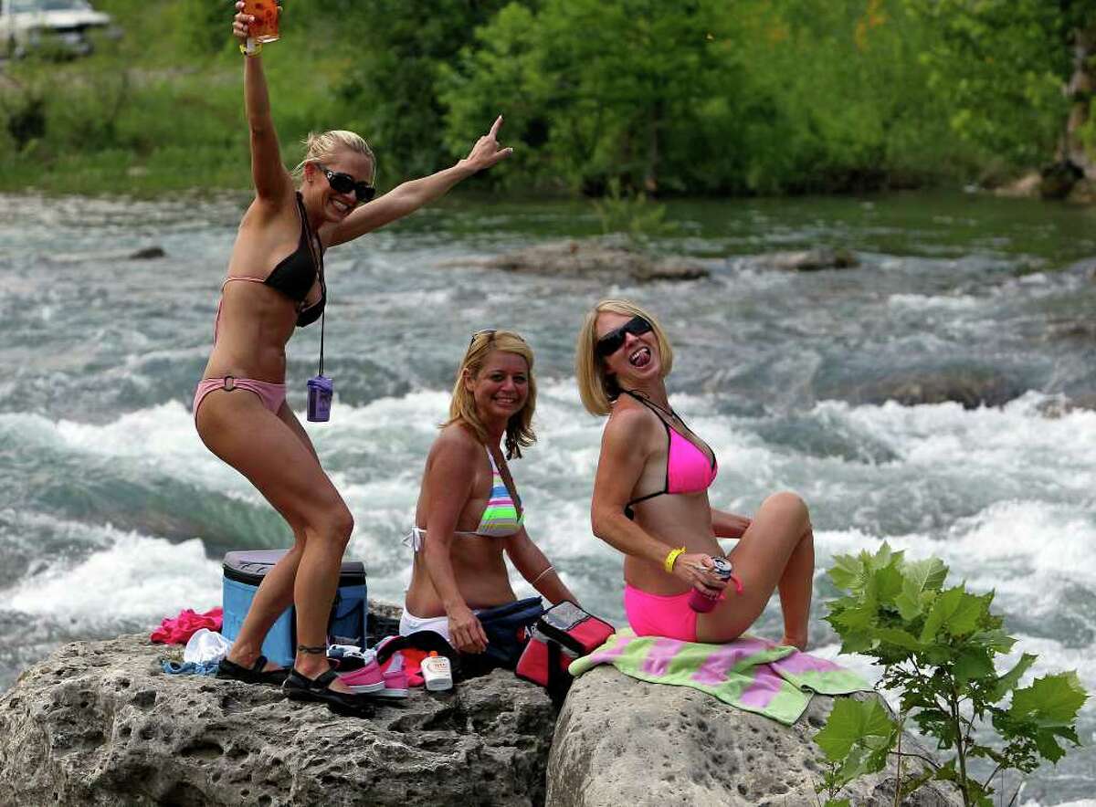 METRO Three women rest on the rocks over rapids on the Guadalupe River on Friday, May 28, 2010. Tom Reel/Staff