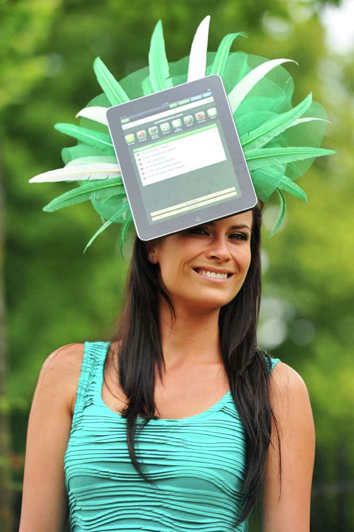 A race-goer wears a hat with an iPad design on the second day of the annual Royal Ascot horse racing event near Windsor, west of London, in Berkshire, on Wednesday. The five-day meeting is one of the highlights of the global horse racing calendar. Horse racing has been held at the famous Berkshire course since 1711 and tradition is a hallmark of the meeting. Top hats and tails remain compulsory in parts of the course while a daily procession of horse-drawn carriages brings the Queen to the course. AFP PHOTO/Carl de Souza