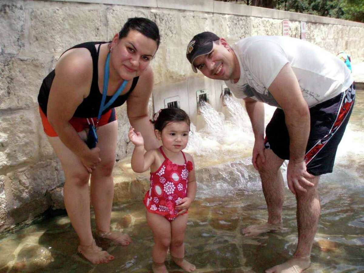 The Bond Family - Melissa, 18-month-old Bella and Robert - enjoy the springs at the San Pedro Park pool during as soon as it opened, Saturday, continuing a 12,000 year tradition.