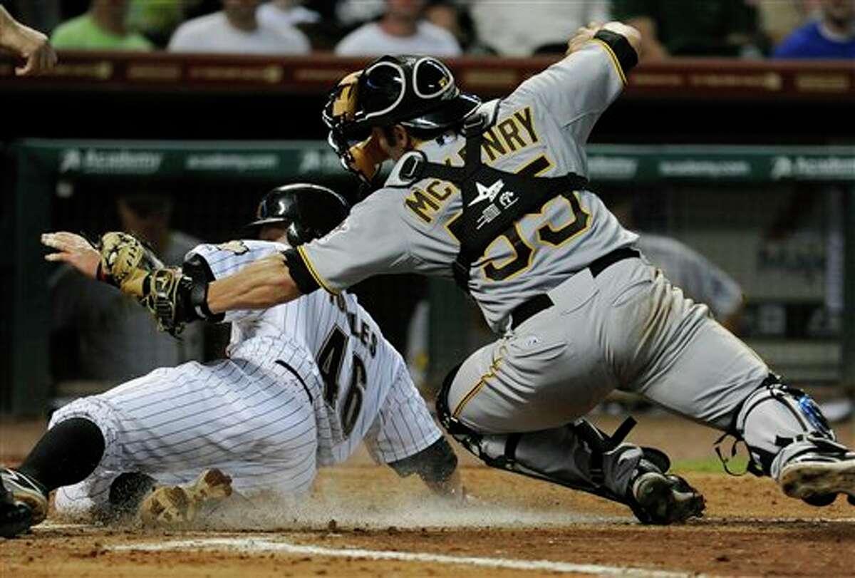 Houston Astros' J.R. Towles (46) slides past Pittsburgh Pirates catcher Michael McKenry's tag and scores in the fourth inning of a baseball game, Wednesday, June 15, 2011, in Houston. (AP Photo/Pat Sullivan)