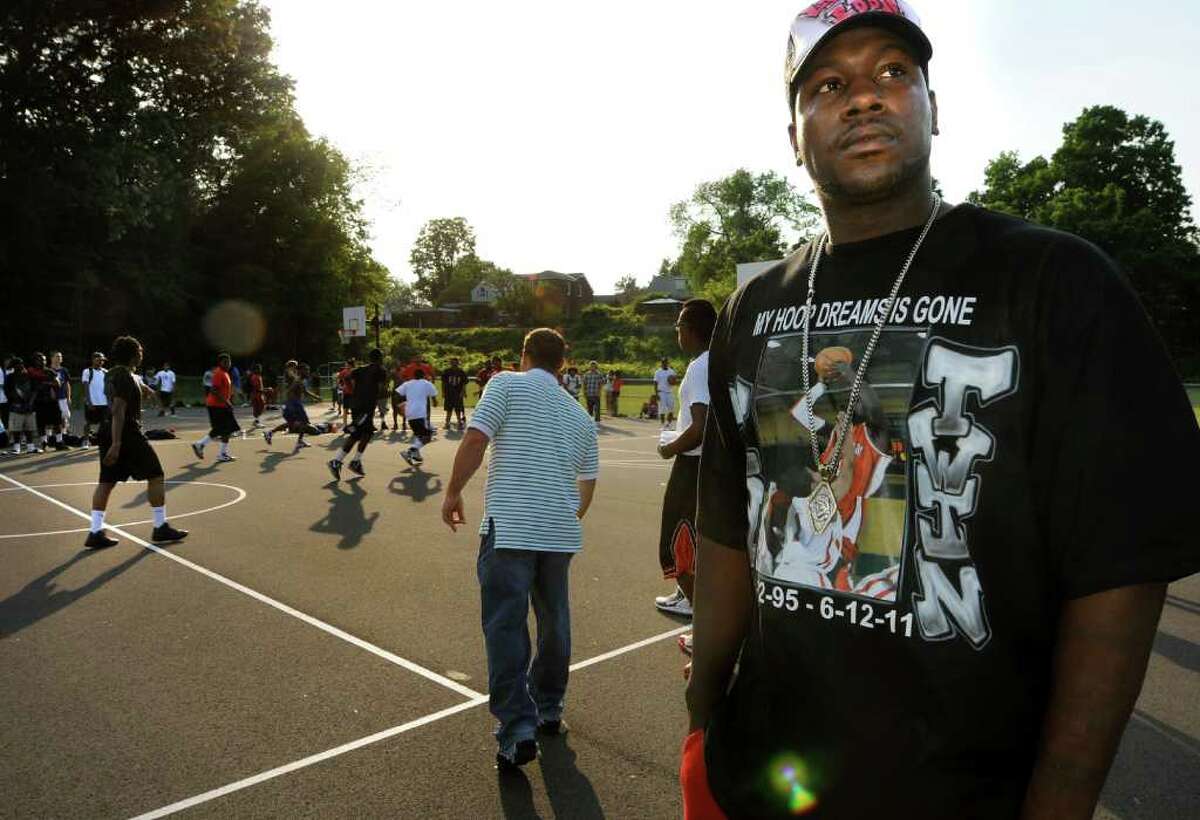 Eddie Stanley Sr., right, wears a shirt in honor of his slain son, Eddie, during a basketball game to help the family with funeral expenses on Thursday, June 16, 2011, at Central Park in Schenectady, N.Y. (Cindy Schultz / Times Union)