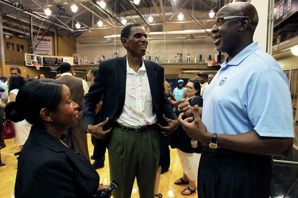 Campy Russell (right) chats with Larry and Vanessa Kenon after the memorial service for Spurs great Mike Mitchell at the Antioch Sports Center on June 16, 2011. Tom Reel/Staff
