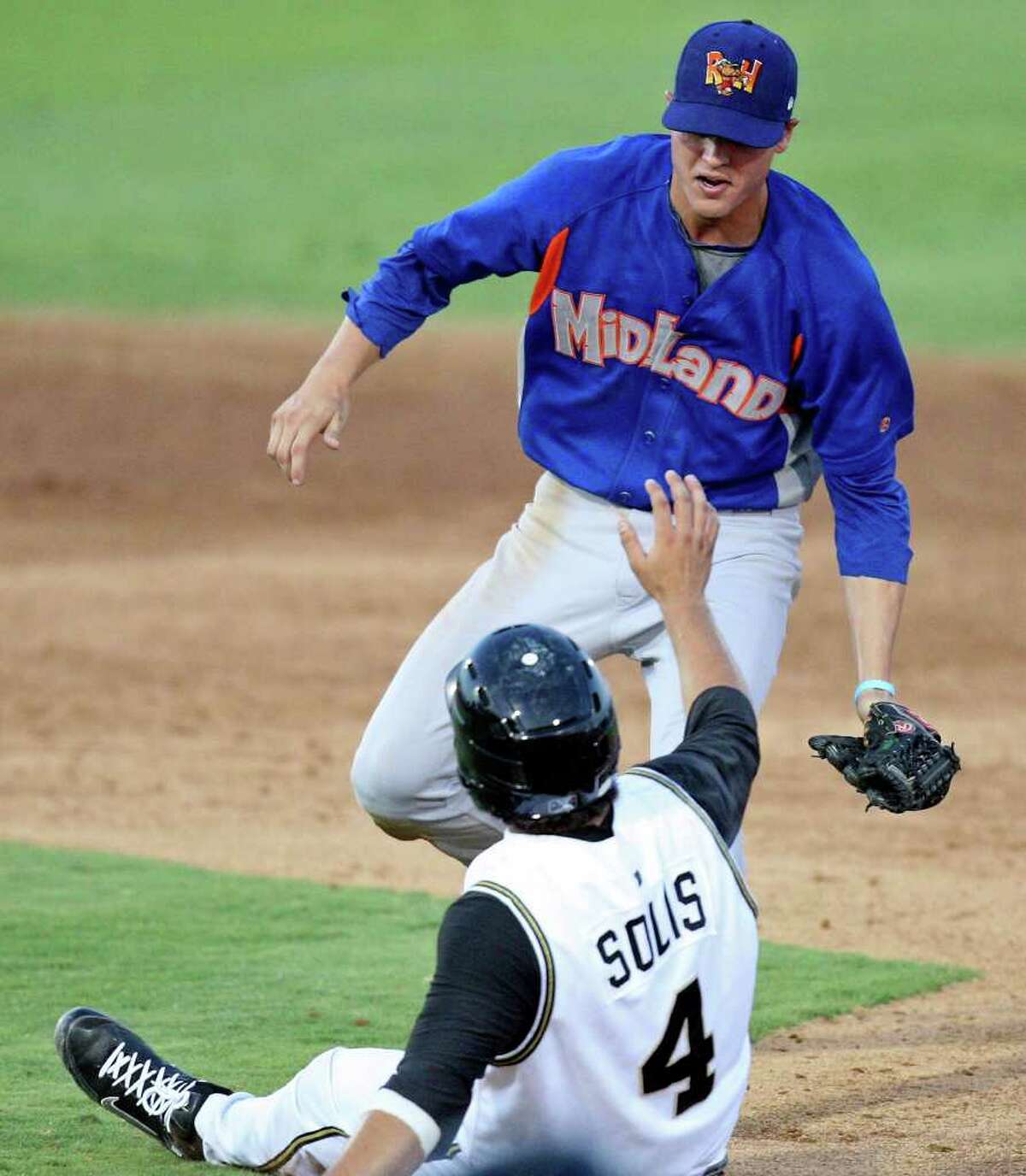 Missions' Ali Solis is tagged out by Rockhounds' Grant Green after slipping during a rundown in the fifth inning.