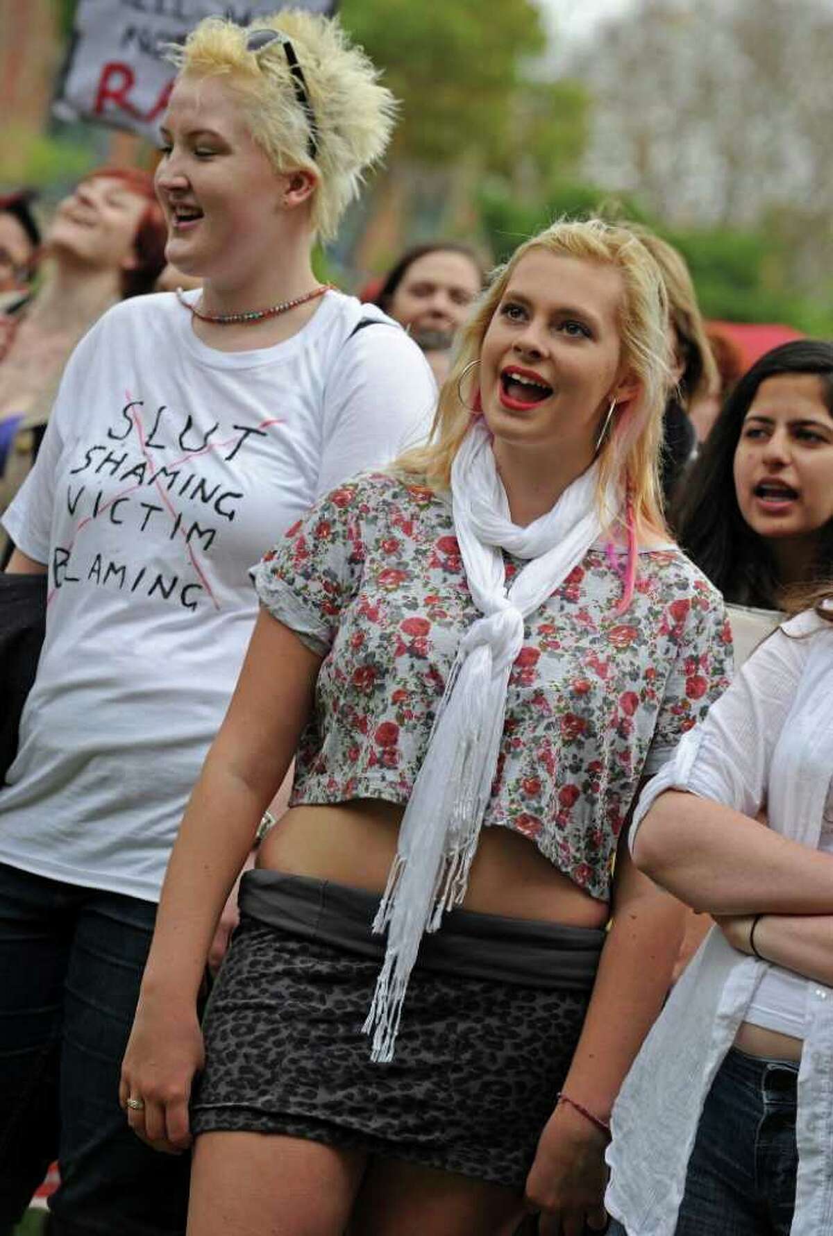 Participants attend a rally following a march for "SlutWalk" through Sydney on June 13, protesting for women to be able to wear whatever they like without fear of being sexually assaulted. A SlutWalk will take place in Seattle on Sunday from Capitol Hill to downtown.SlutWalk began in Canada in April after a Toronto police official said that "women should avoid dressing like sluts in order not to be victimised". AFP PHOTO / Greg WOOD