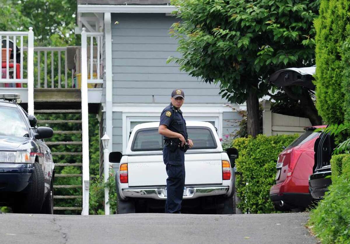 A Greenwich police officer stands guard on Fox's Lane, Greenwich, Friday afternoon, June 17, 2011. A 2-year-old Chickahominy boy died in an apparent drowning along with his grandmother in a man-made koi pond on Fox's Lane Thursday.
