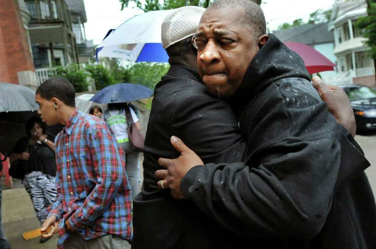 Fred Gentry, Eddie Stanley's great uncle, right, embraces Ro Caldwell outside during June 17, 2011, calling hours at Refreshing Spring Church in Schenectady. Stanley, 15, was killed at a party June 12, 2011. (Cindy Schultz / Times Union)