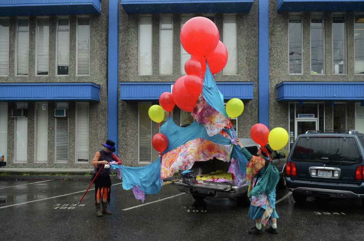 Gretchen Lawlor, left, and Sonia Telesco prepare their balloon display before the start of the Fremont Solstice Parade on Saturday, June 18, 2011 in Seattle. Lawlor, the treasurer of the Fremont Arts Council, said she has been attending the parade for 14 years.