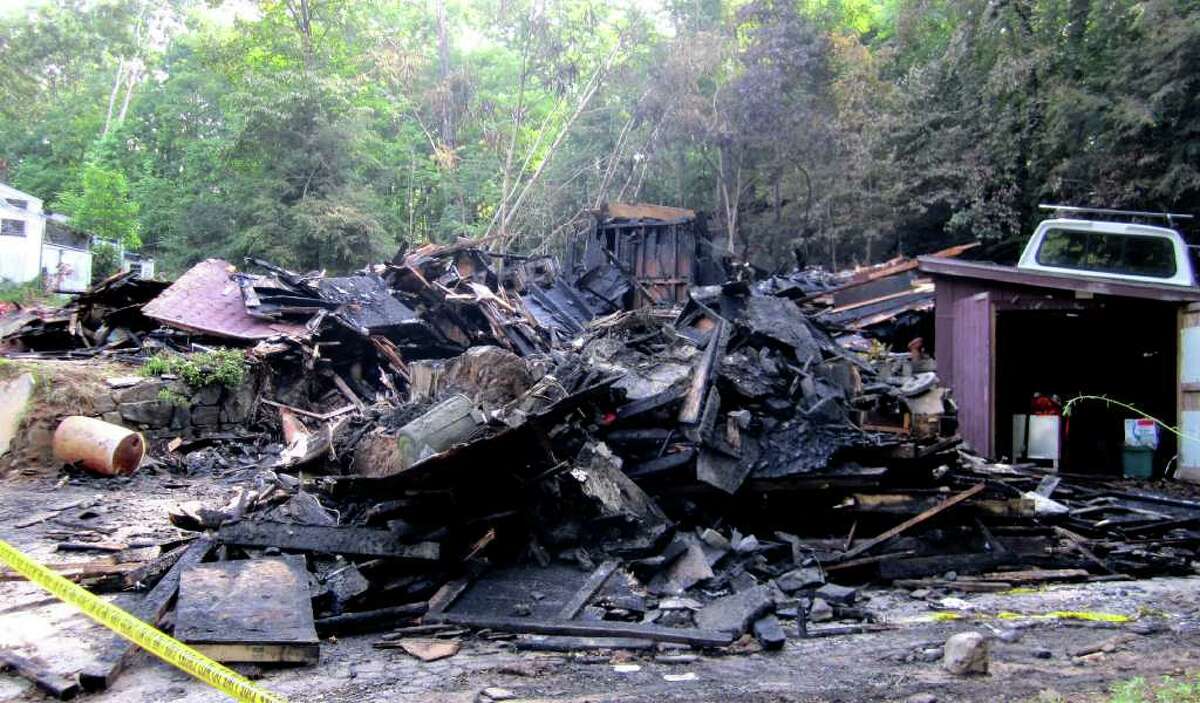 SPECTRUM/Little more than charred rubble remained of a home at 175 Pumpkin Hill Road in New Milford after at the late-evening fire of June 17, 2011.