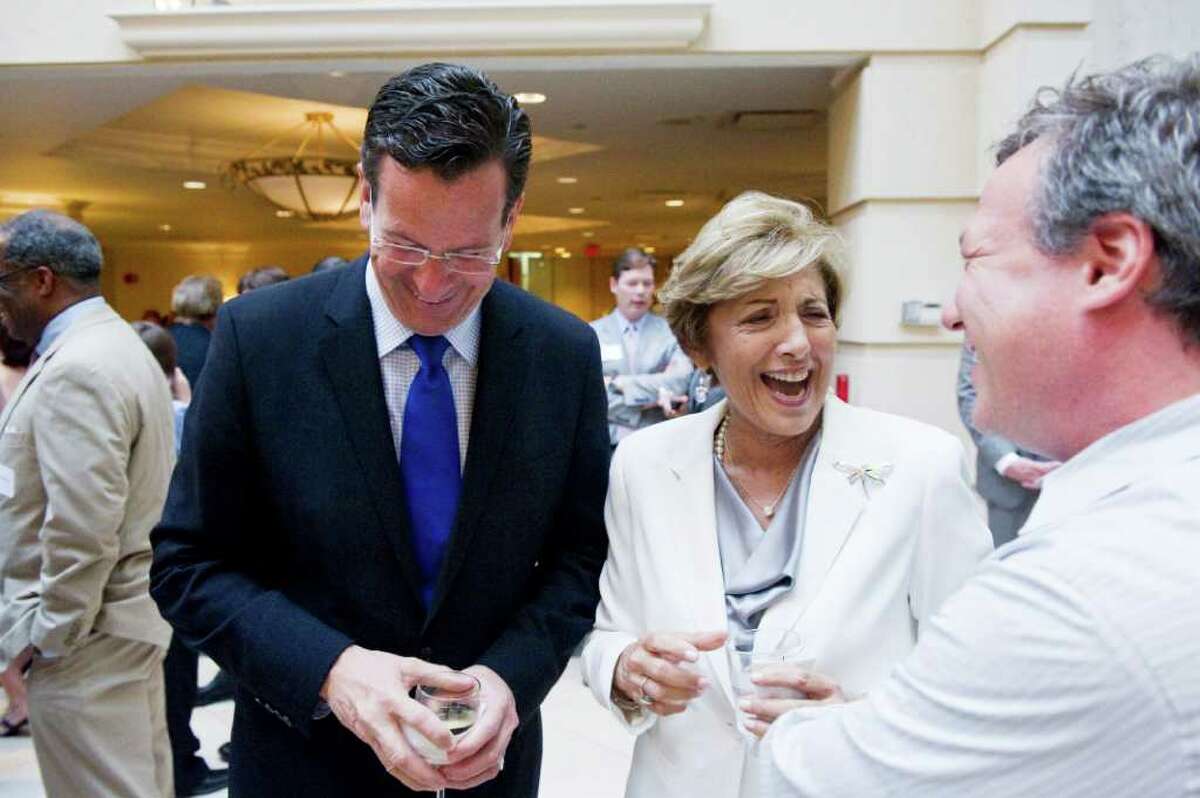 Gov. Dannel P. Malloy and Sandy Goldstein, president of the Downtown Special Services District, share a laugh with Kevin Segalla of the Connecticut Film Center before the DSSD's annual meeting at Stamford Marriott Hotel & Spa in Stamford, Conn., June 20, 2011. Malloy delivered the keynote speech during meeting.