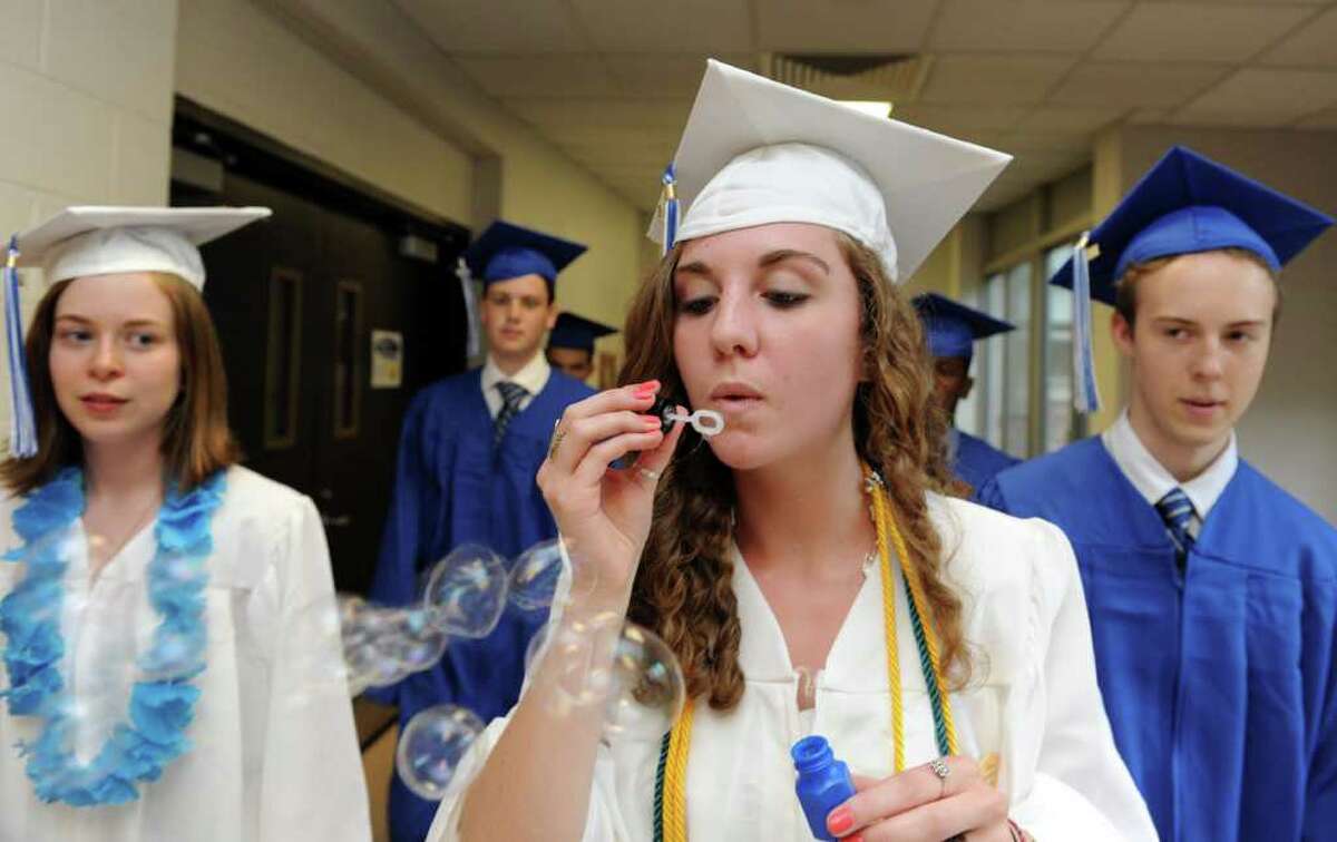 Graduate Michaela Fraser blows bubbles as the class of 2011 marches into the auditorium for Fairfield Ludlowe High School's commencement ceremony Thursday, June 23, 2011.