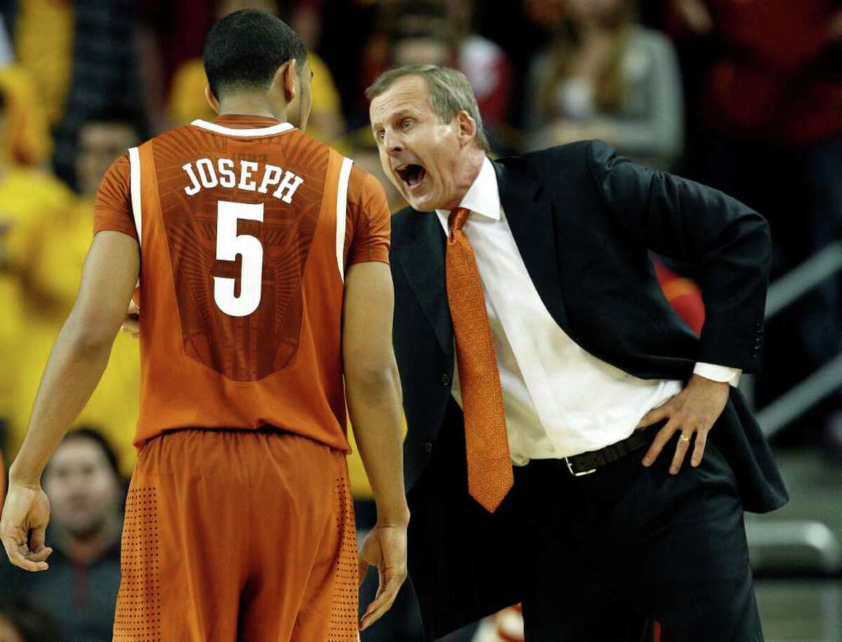 Texas head coach Rick Barnes, right, talks to guard Cory Joseph during the second half of an NCAA college basketball game against Southern California in Los Angeles, Sunday, Dec. 5, 2010. Southern California won 73-56. (AP Photo/Jason Redmond)